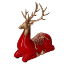 Renna resina seduta oro e rosso cm 17x8xh20